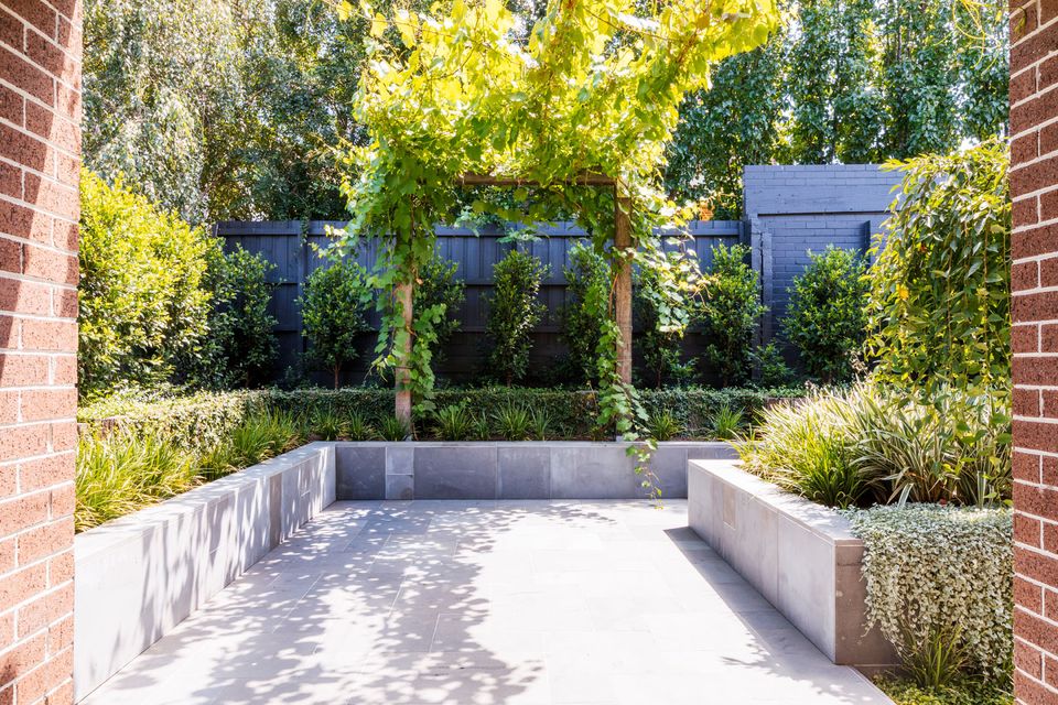 The Brunswick West garden — layered planting around a bluestone terrace