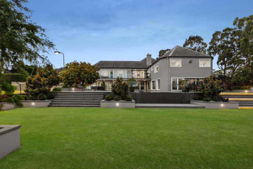 Broad steps rising through terraced lawns to the house