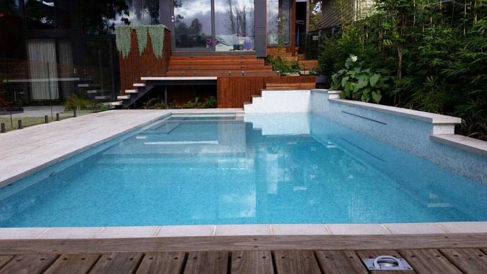 Swimming pool and timber deck with steps beyond